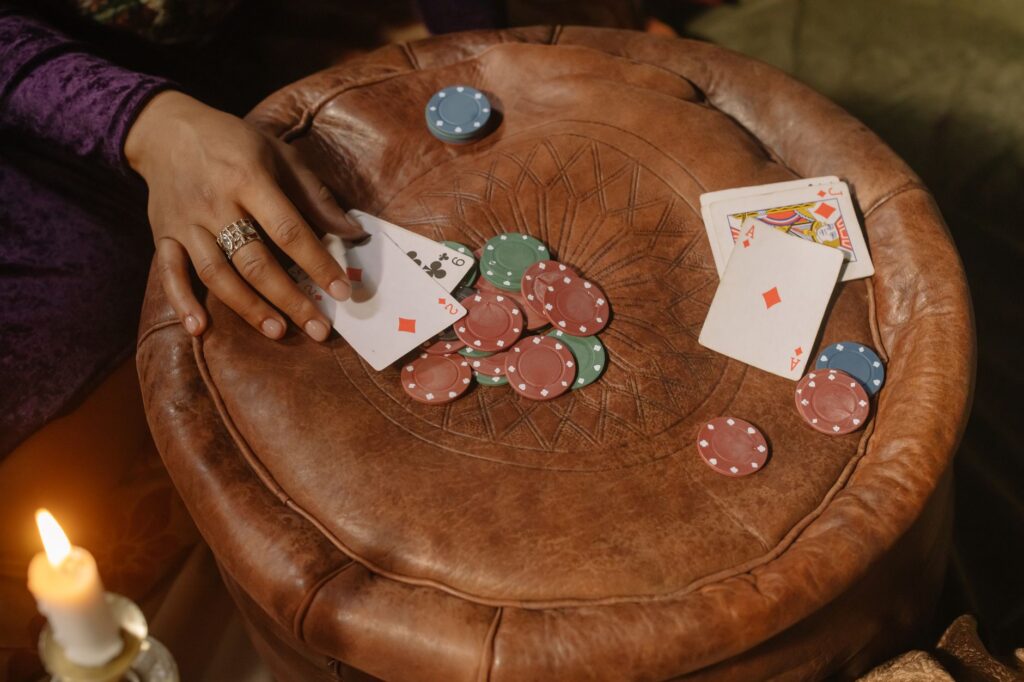 Stacked casino chips on dark felt table under low light