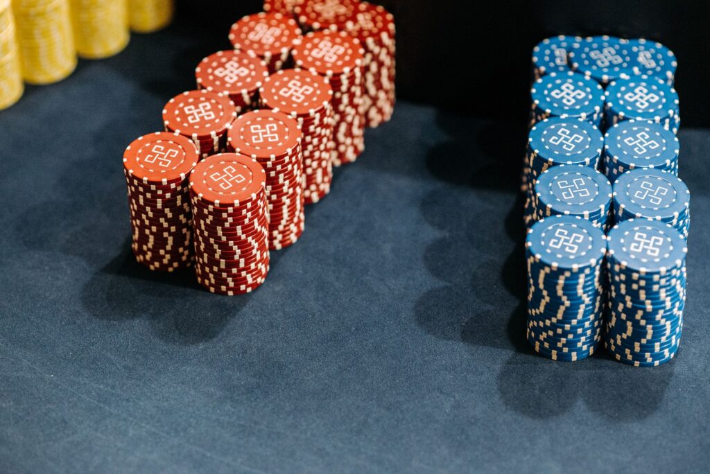 Casino chips and cards scattered on a table under low light