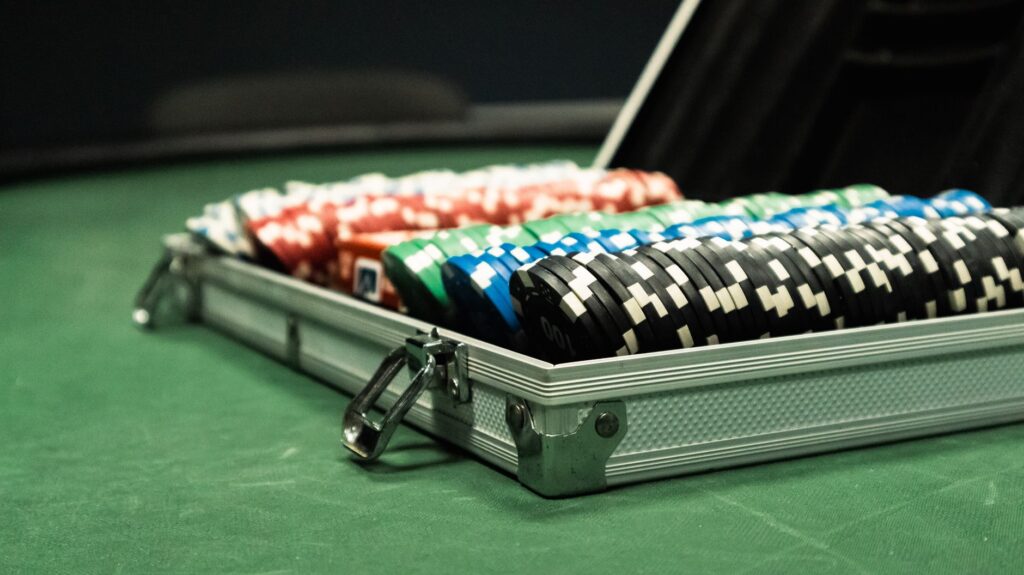 Stacked casino chips under low, moody lighting on a table