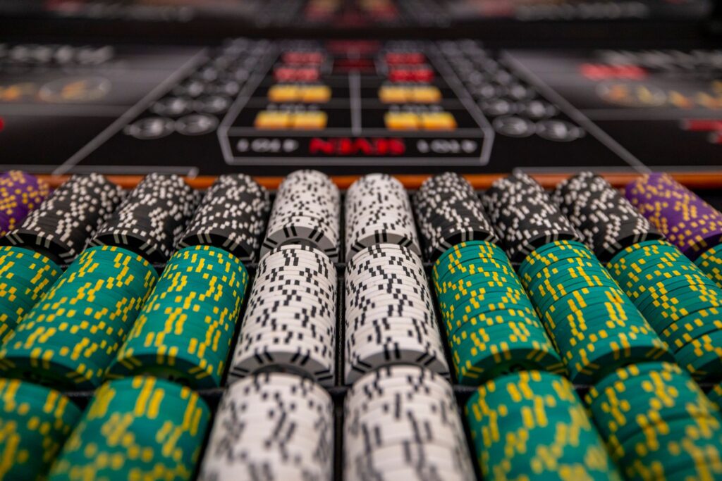 Casino chips and cards scattered on a dark table under low light