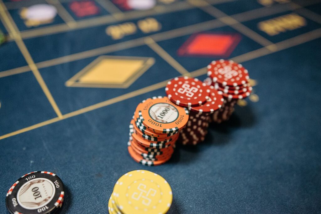Roulette table with stacked casino chips of various colors and denominations