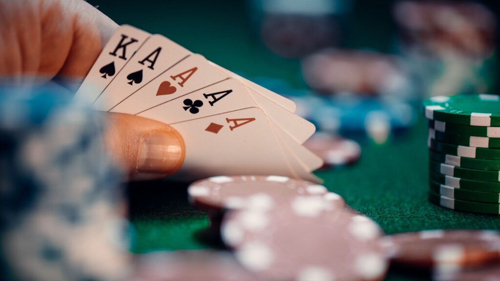 Stack of casino chips and playing cards under low light