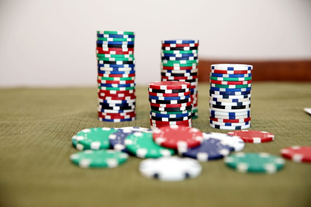Stacked casino chips on a dark table under low light